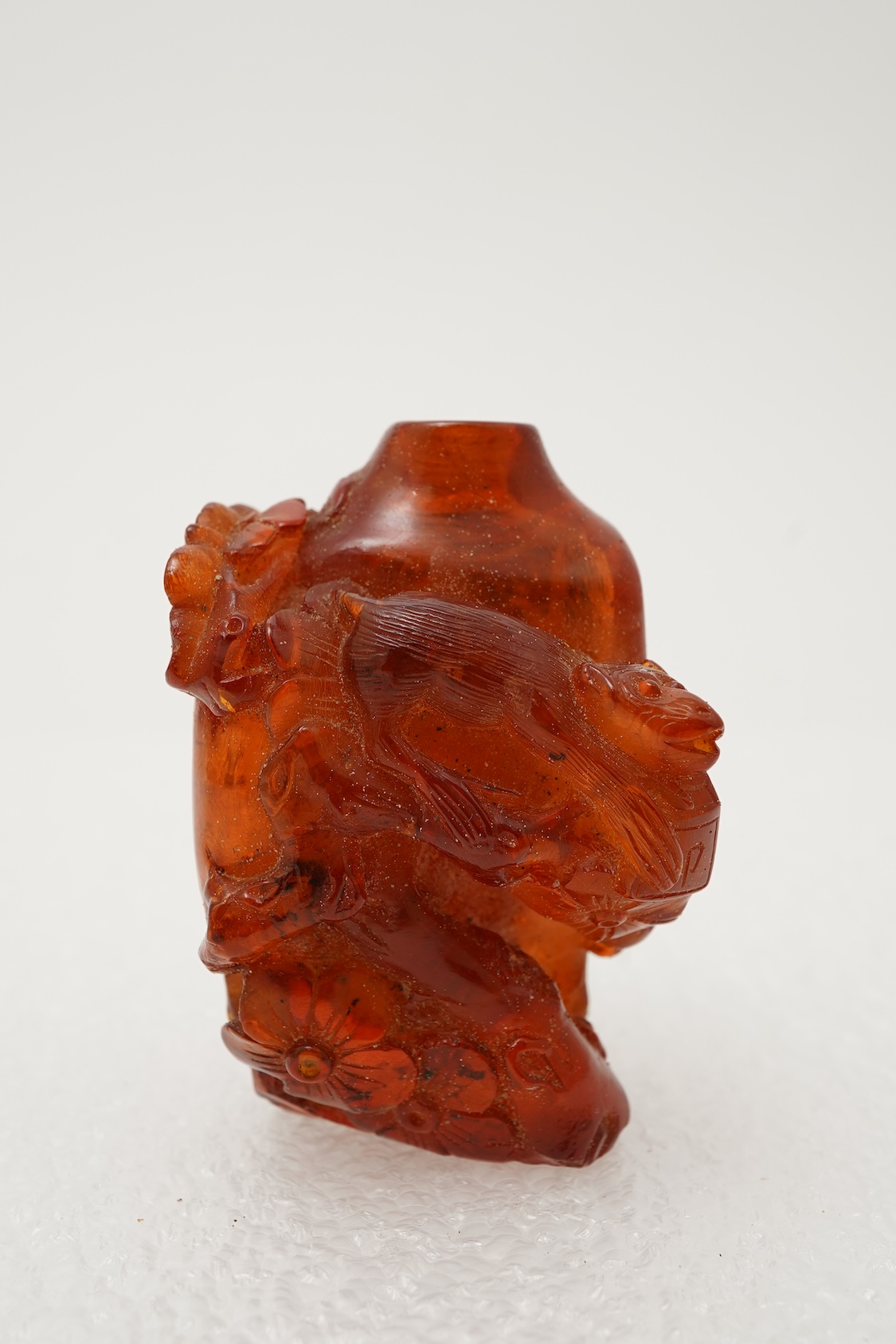 A Chinese caved amber snuff bottle, 19th century